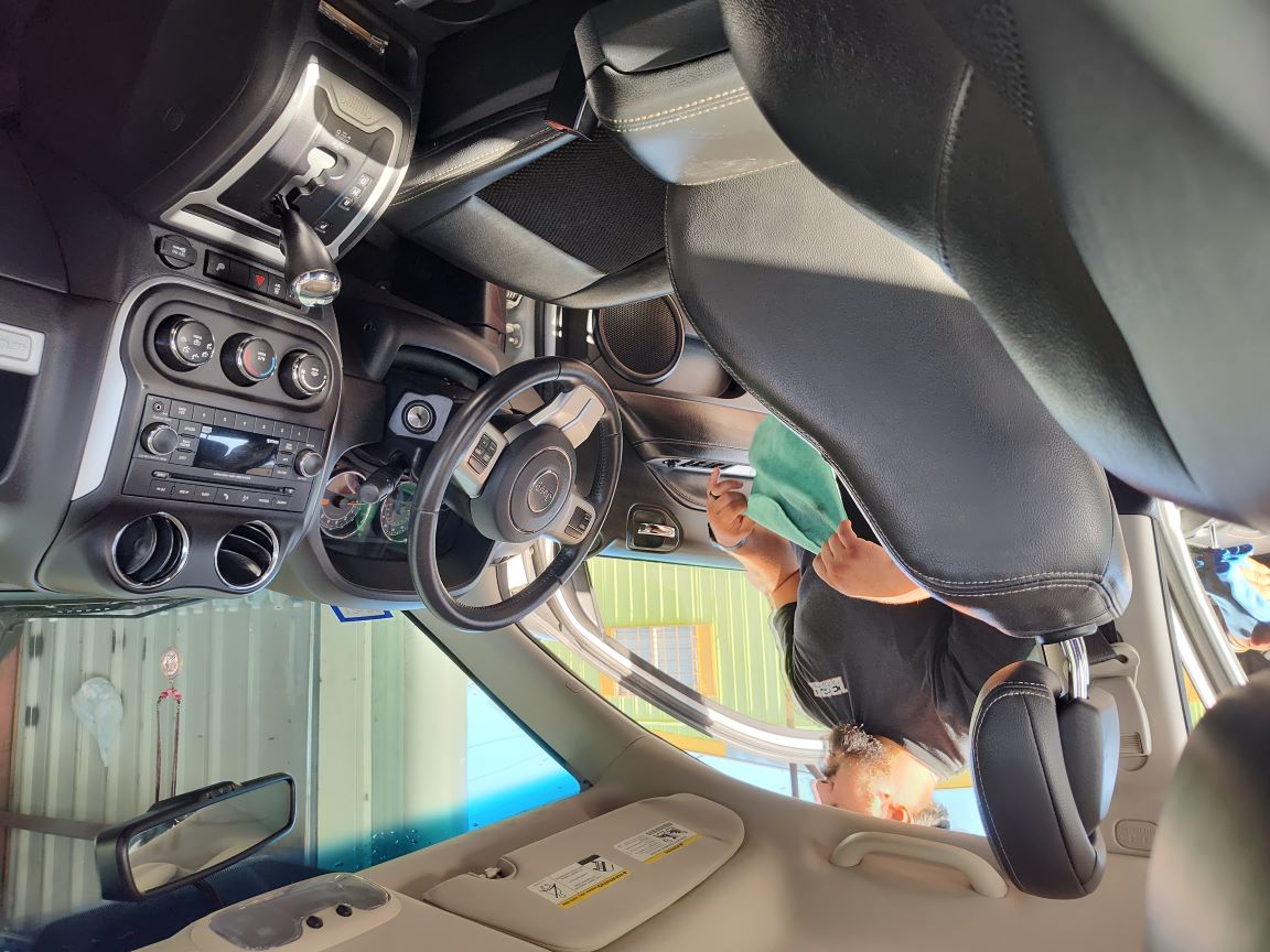 John cleaning a dashboard